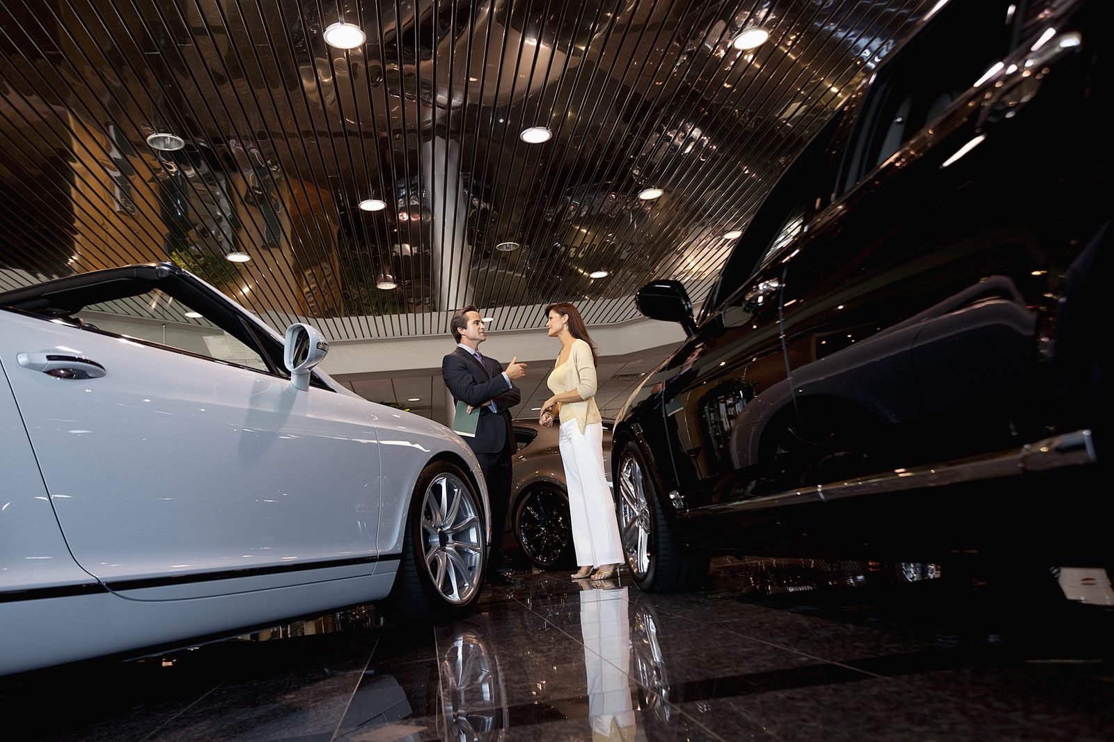 Low angle of luxurious car in a exclusive showroom with vehicles