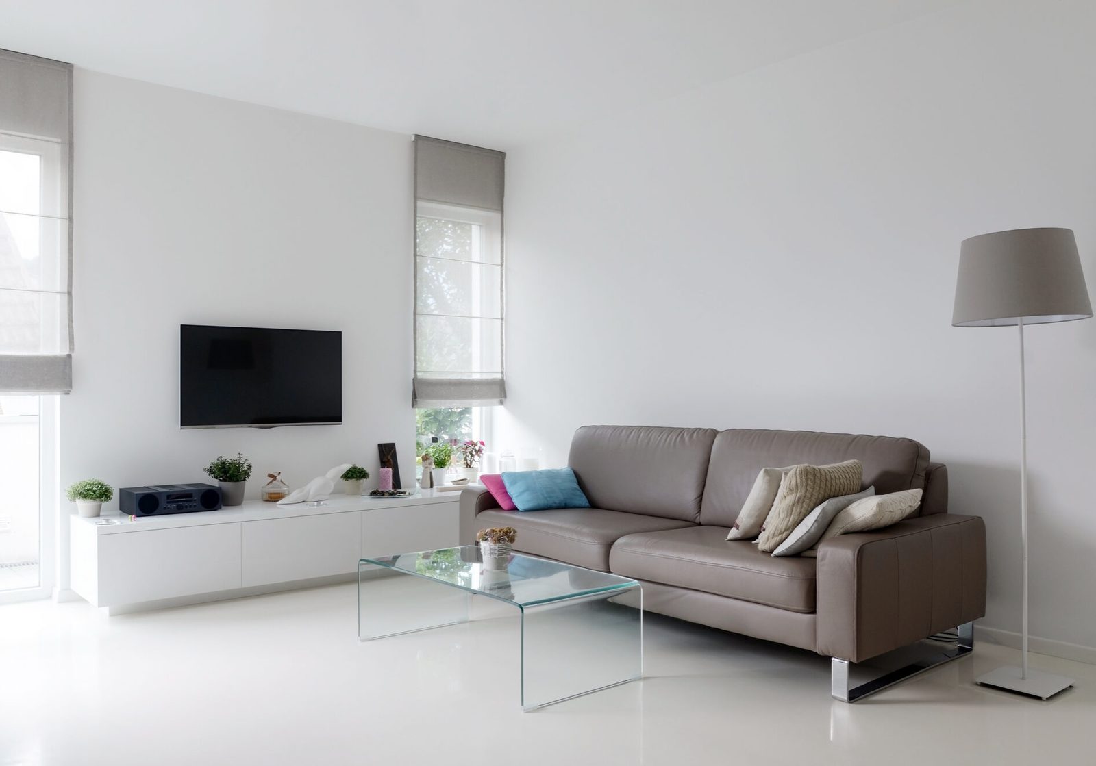 White living room with taupe sofa